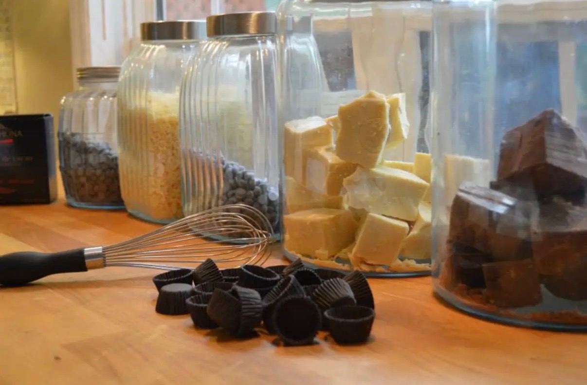 Chocolate-making ingredients arranged on a work table.
